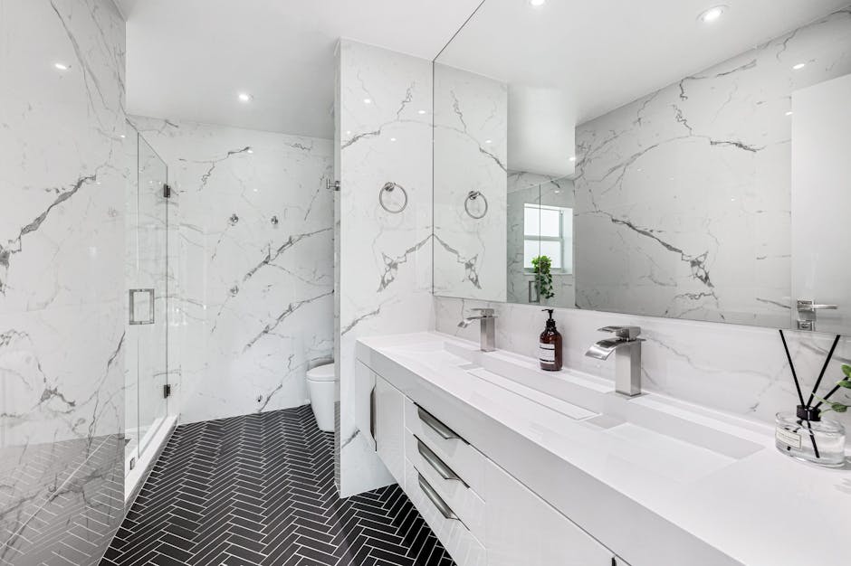 Explore the elegance of a modern bathroom featuring marble walls and sleek fixtures.
